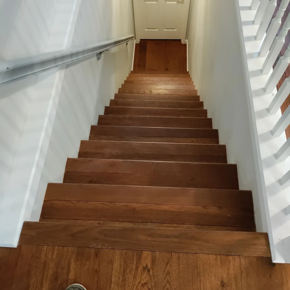 Dark hardwood stair landing and treads